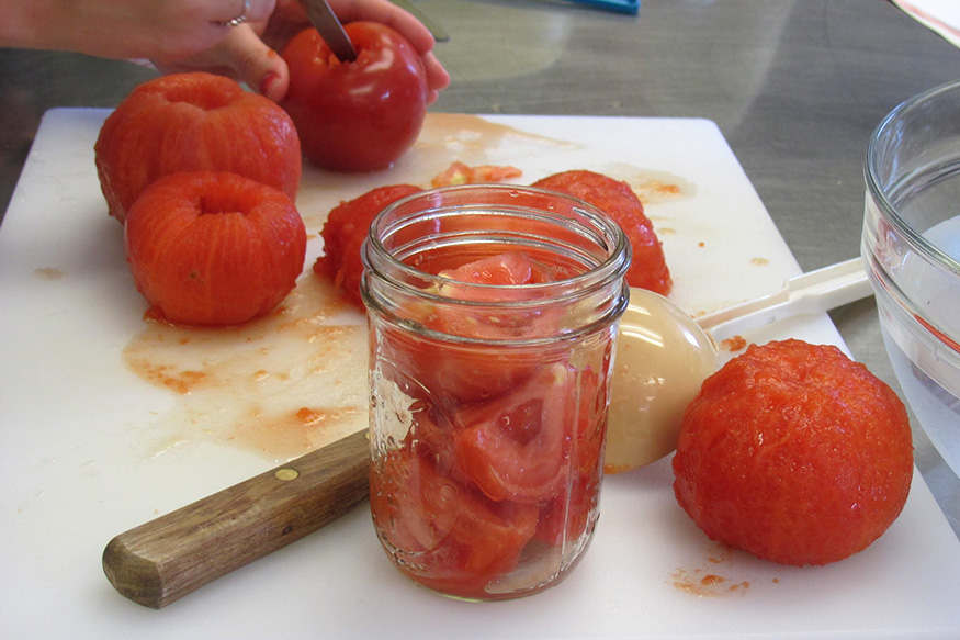 tomatoes on cutting board and in mason jar